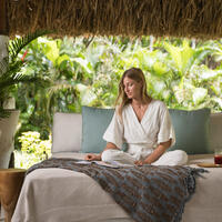 A guest relaxing on a lounge at the Yaukuve Spa Sanctuary at Kokomo Private Island Fiji