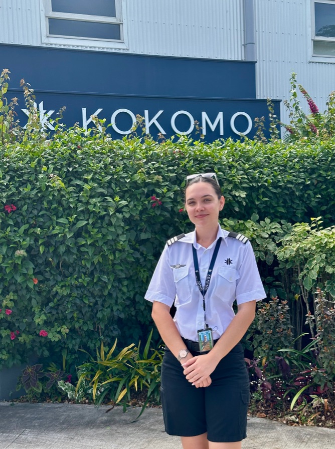 Cynthia standing in front of a Kokomo sign.