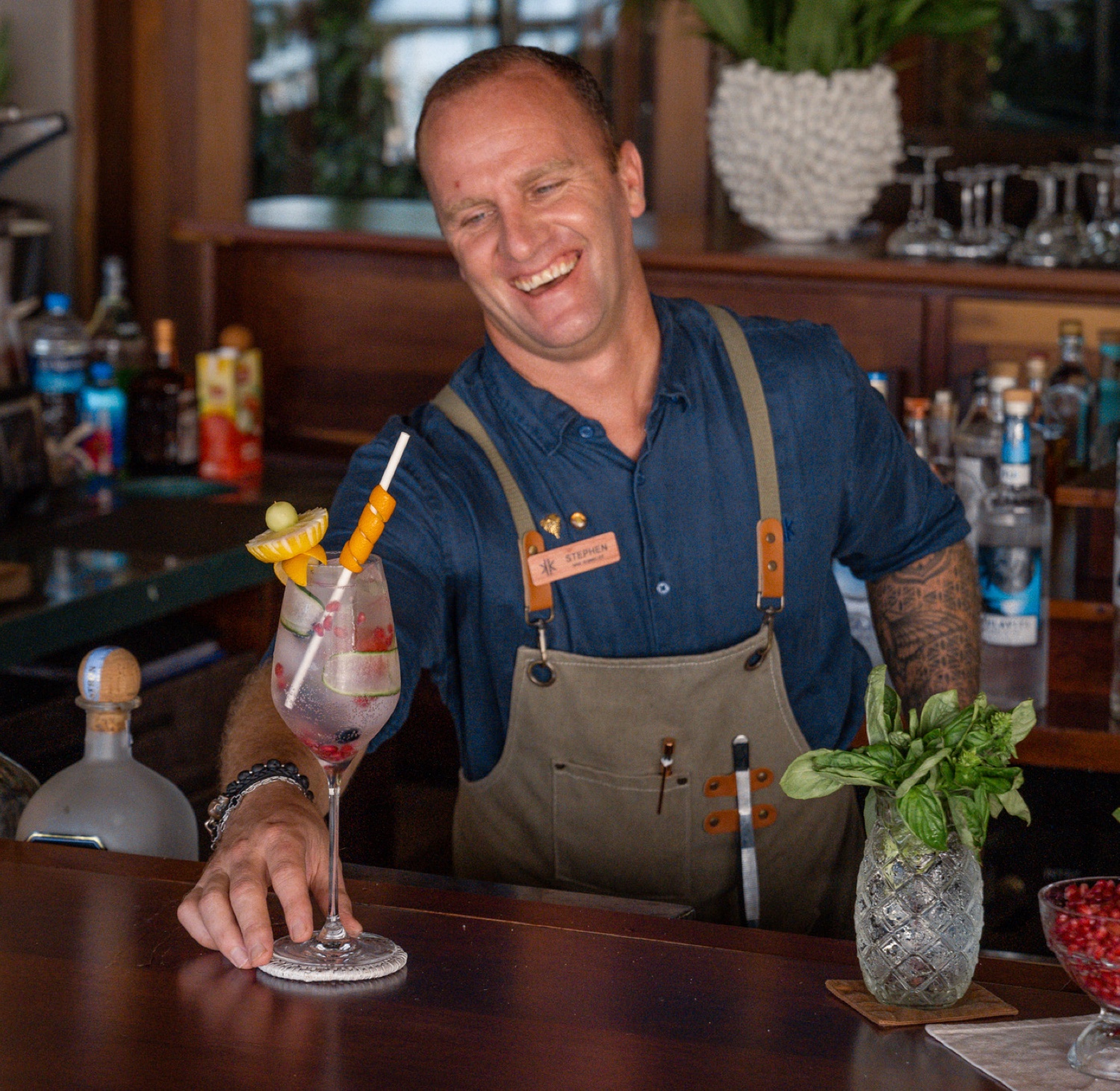 Stephen, Kokomo's resident sommelier, having just freshly made a cocktail, moving it across the bar.