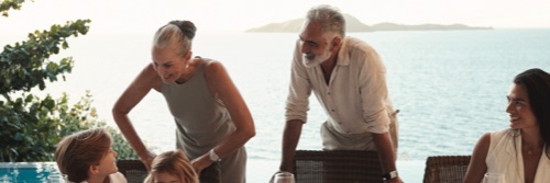 A bride and groom walking towards the beach at Kokomo Private Island Fiji.
