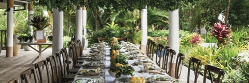 A bride and groom walking towards the beach at Kokomo Private Island Fiji.