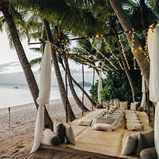 A table close to the beach at Kokomo Private Island Fiji set up for dining.
