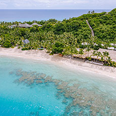 Some beachfront villas and residences viewed from the water at Kokomo Private Island Fiji.