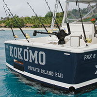 Multiple fishing rods sitting on the back of Kahala stationary off the coast of Kokomo Private Island Fiji