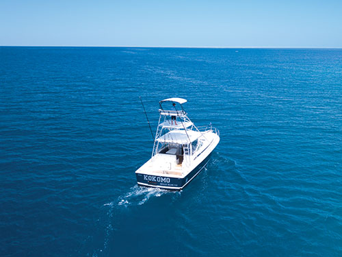 The fishing boat ‘Kahala’ out on the water off the coast of Kokomo Private Island Fiji.