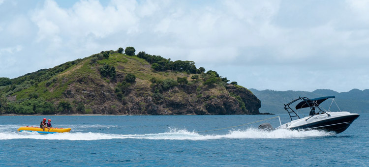 'Ski Kokomo' out towing guests on an inflatable off the coast of Kokomo Private Island Fiji