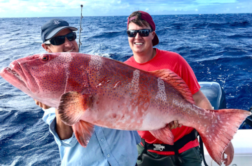 Jaga and guest holding large fish caught on a Kokomo Private Island Fiji fishing trip