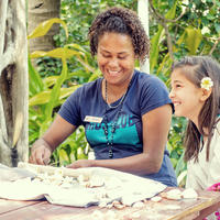 A Kokomo Private Island team member teaching crafts to a child in the Kids Club