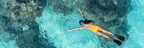 A guest snorkeling at the reefs off Kokomo Private Island Fiji.