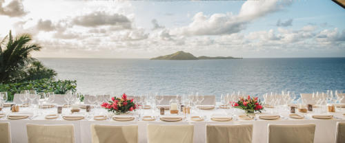 A dining setting overlooking the ocean at Kokomo Private Island Fiji.