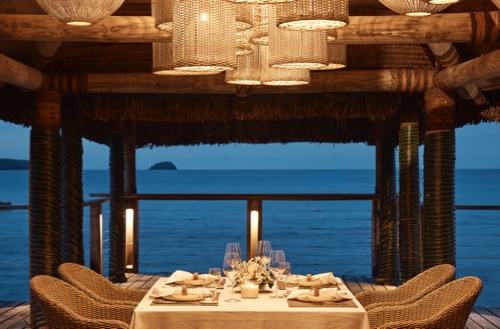 Table set up for dining overlooking the water at Kokomo Private Island.