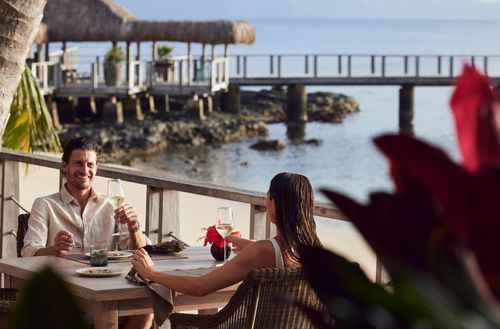 A couple enjoying a romantic dinner together at Kokomo Private Island Fiji.