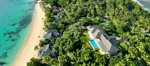 A bird’s eye view of beachfront villas and a luxury residence set atop the hill at Kokomo Private Island Fiji.