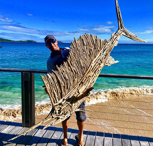 Jaga holding wooden fish