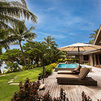 The façade and patio area of a luxury villa at Kokomo Private Island Fiji.