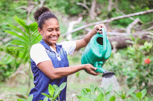 Kokomo Private Island staff member watering plants on the island