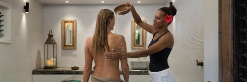 A guest receiving a treatment in a private treatment room at Kokomo Private Island Fiji.